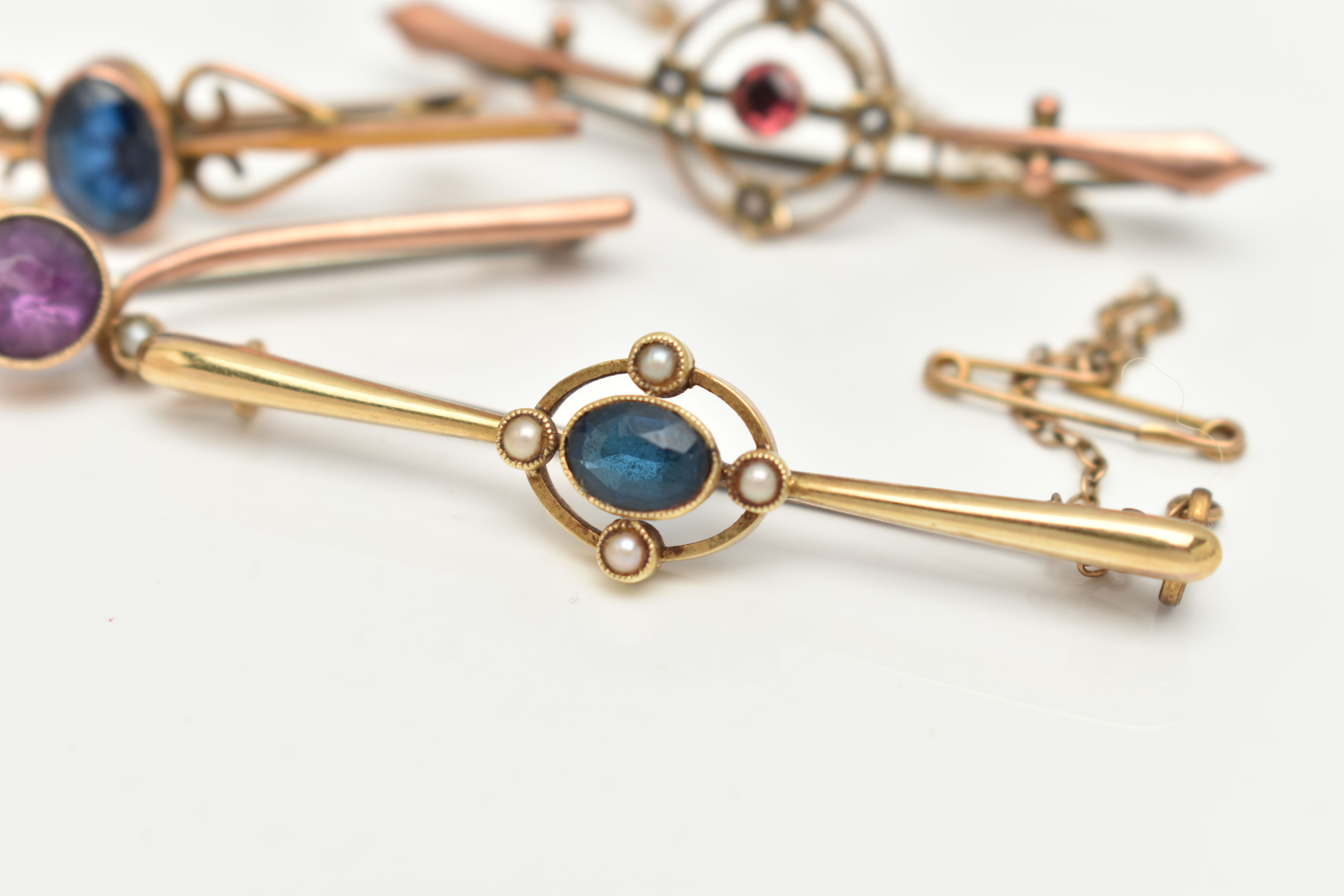 FOUR BAR BROOCHES, the first a yellow metal brooch set with a central oval cut blue sapphire in a - Image 3 of 5