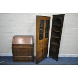 AN EARLY 2OTH CENTURY OAK BOOKCASE, the fall front door enclosing a fitted interior, above three