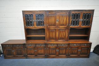 AN OLD CHARM WALL CABINET, each base fitted with two drawers, above double cupboard doors, two top