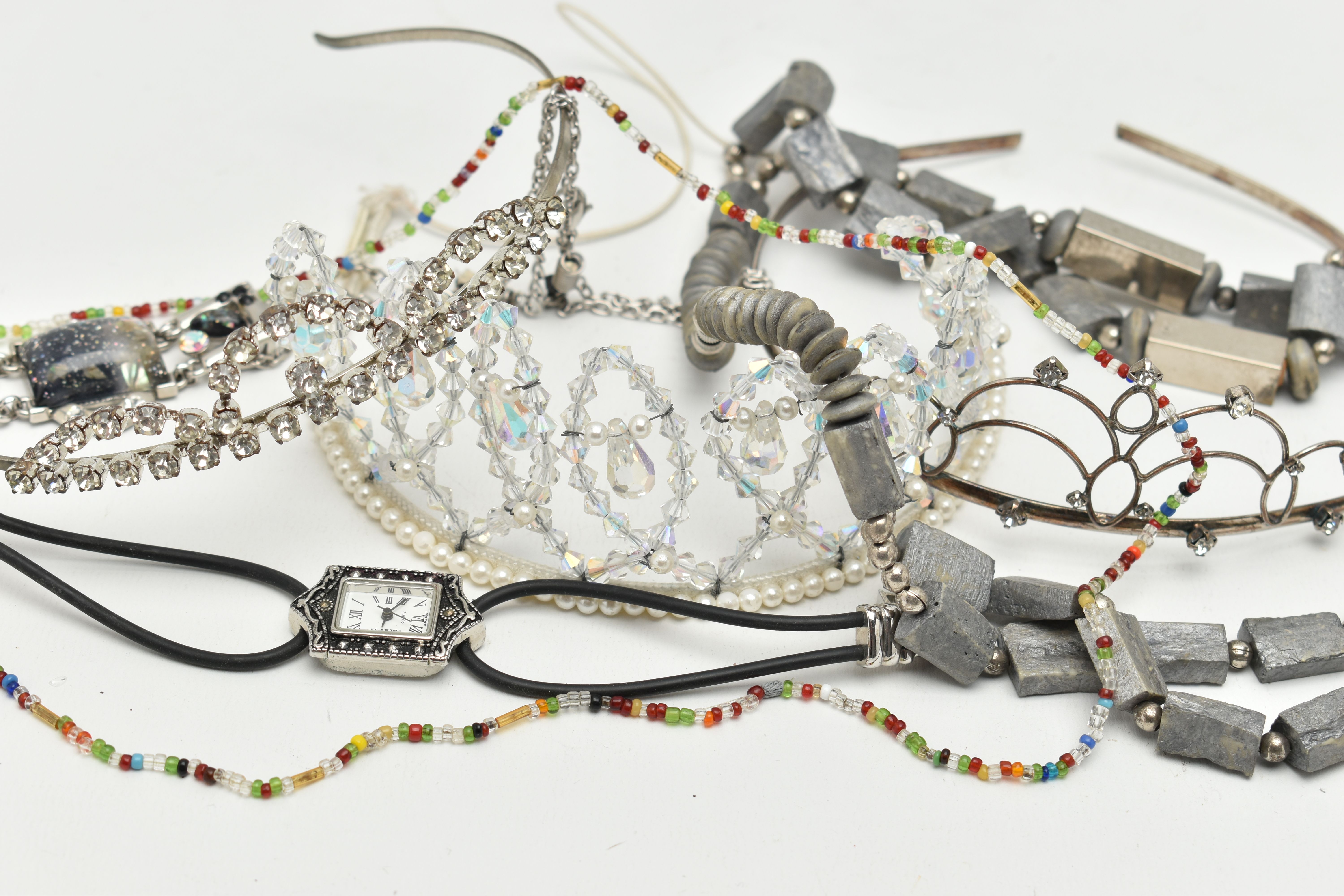A BAG OF ASSORTED ITEMS, to include two paste set white metal tiaras, a faceted bead tiara, chunky