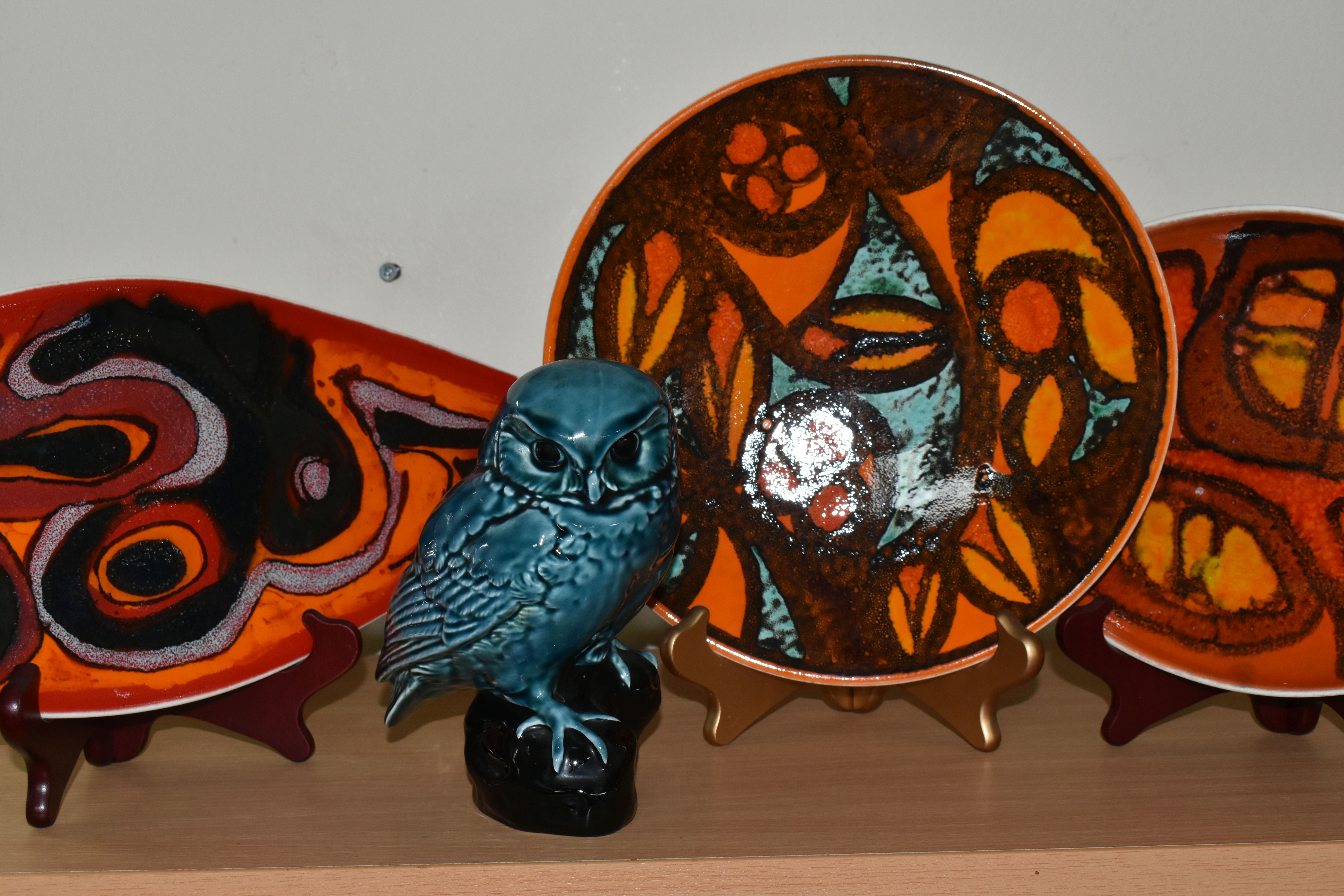 FOUR PIECES OF POOLE POTTERY, comprising a Delphis plate and two dishes: the plate 26.5cm in