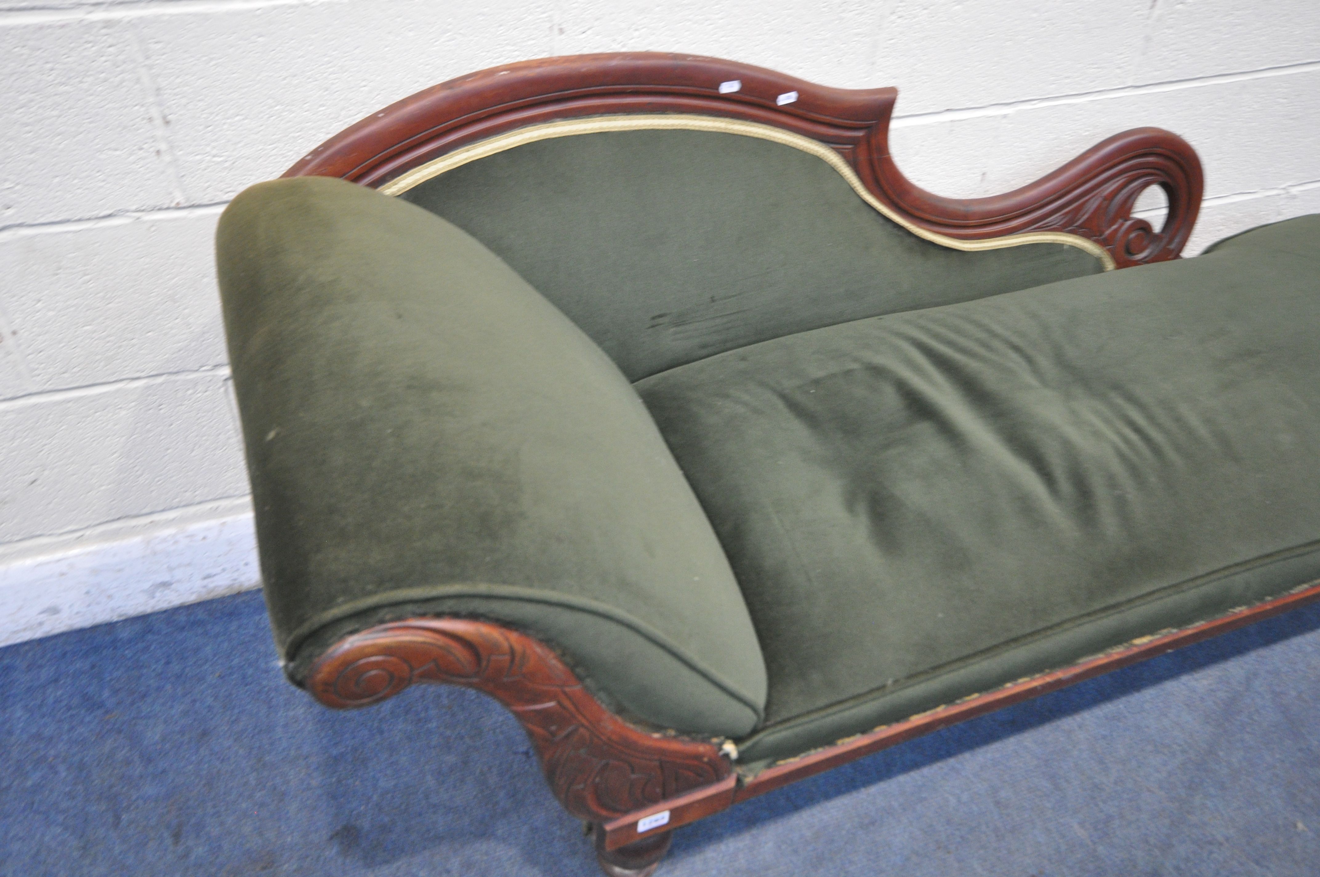 AN EARLY 20TH CENTURY CHAISE LOUNGE, with scrolled backrest, green upholstery, raised on turned - Image 2 of 3