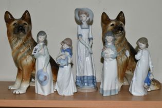 FIVE NAO FIGURES AND TWO FIGURES OF GERMAN SHEPHERD DOGS, the Nao figures comprising a girl with a