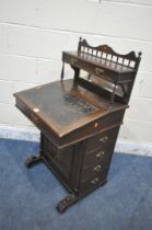 AN EDWARDIAN MAHOGANY DAVENPORT, with a raised back that's fitted with two drawers, above a hinged