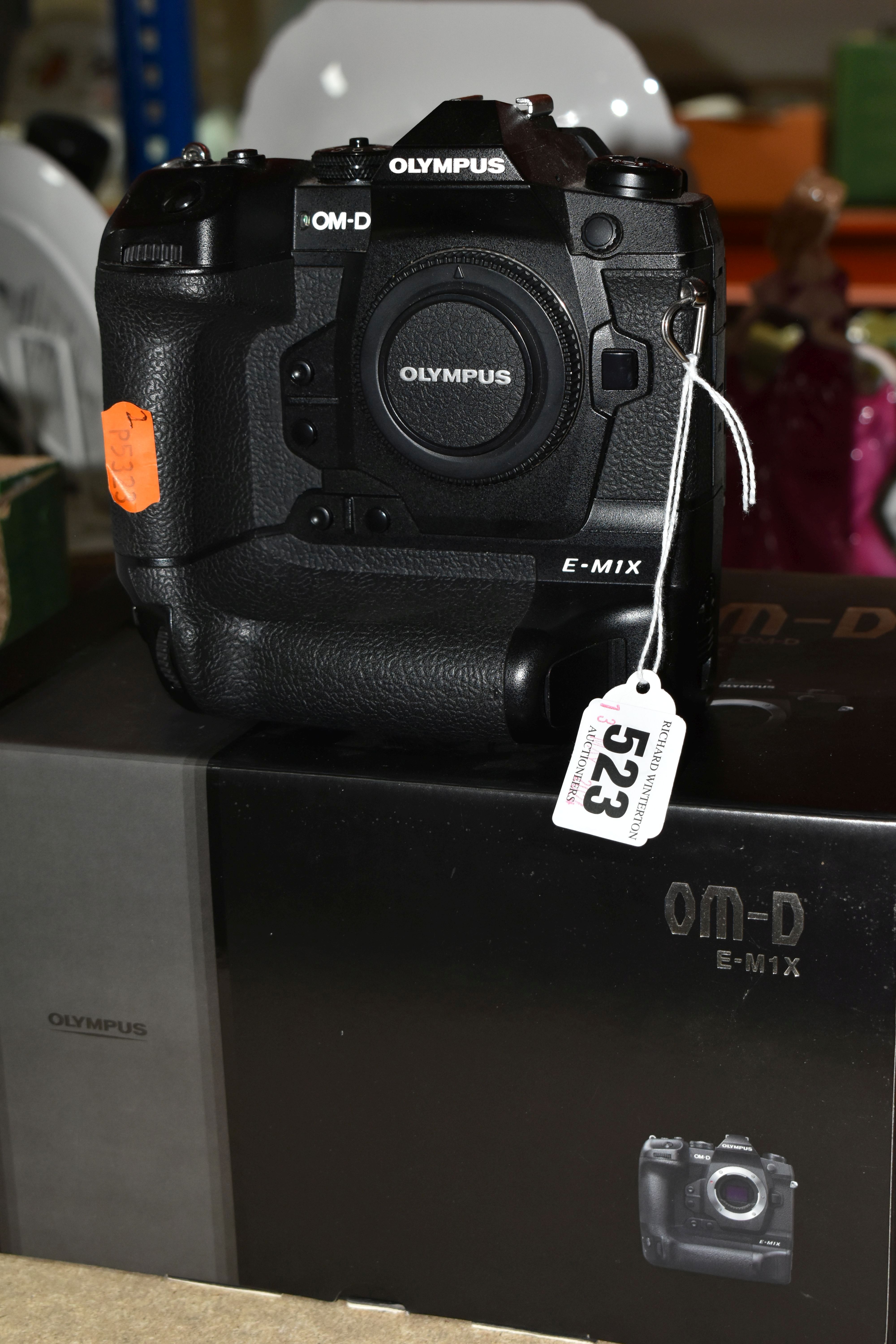AN OLYMPUS OM-D E-M1X MIRRORLESS 4/3 CAMERA BODY, complete with battery charger (no UK power cable),