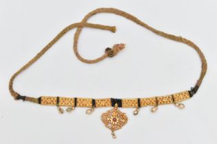 AN INDIAN NECKLACE, designed with a central fancy floral and beaded pendant with central ruby