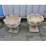 A PAIR OF MODERN COMPOSITE GARDEN URNS with foliate detail to bowls both in two sections 46cm in