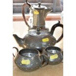 AN EARLY 20TH CENTURY ARTS & CRAFTS PLANISHED PEWTER TEA SET, comprising teapot, hot water jug, milk