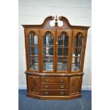 A LATE 20TH CENTURY HARDWOOD BOOKCASE, the twin swan neck pediment, flanking a finial, four glazed
