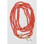 A CORAL BEAD NECKLACE, triple strand of round polished graduated coral beads, fitted with a yellow