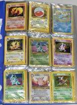 FOLDER OF POKEMON CARDS, includes cards from Base Set, Jungle Set and Fossil set, card condition