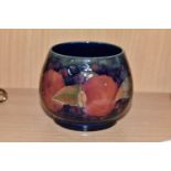 A MOORCROFT POTTERY POMEGRANATE PATTERN SUGAR BOWL, the footed bowl tube lined with fruit on a