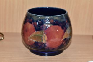A MOORCROFT POTTERY POMEGRANATE PATTERN SUGAR BOWL, the footed bowl tube lined with fruit on a