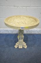 A SMALL IVORINE CIRCULAR TABLE, the top with people riding a horse drawn carriage, the pedestal with