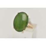 A YELLOW METAL, NEPHRITE CABOCHON RING, of an oval form, nephrite measuring approximately length