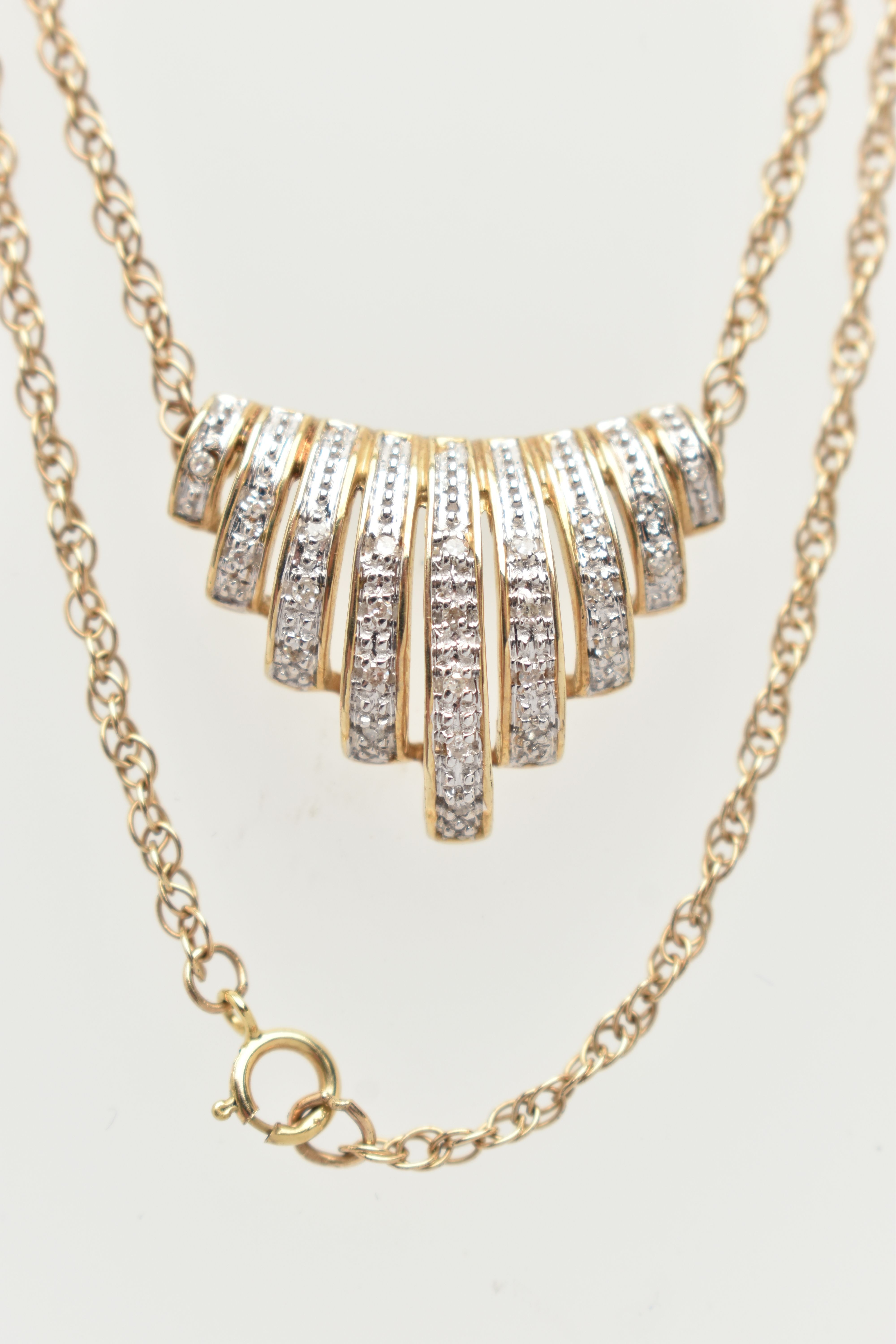 A 9CT GOLD DIAMOND NECKLACE, designed as a central panel of graduated lines set with single cut