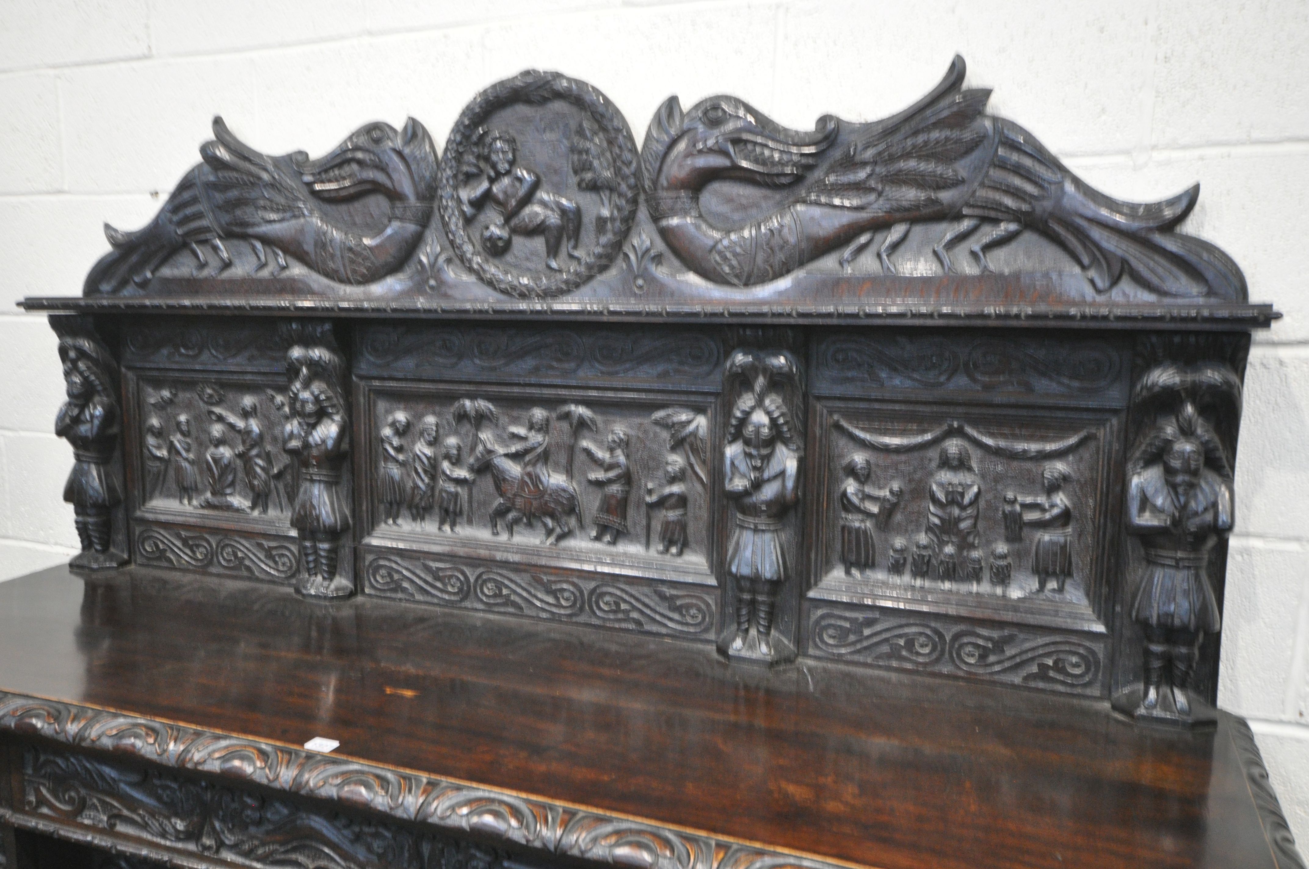 A 19TH CENTURY HEAVILY CARVED OAK SIDEBOARD, the raised back with panelling and shelf, fitted with - Image 2 of 10