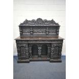 A 19TH CENTURY HEAVILY CARVED OAK SIDEBOARD, the raised back with panelling and shelf, fitted with