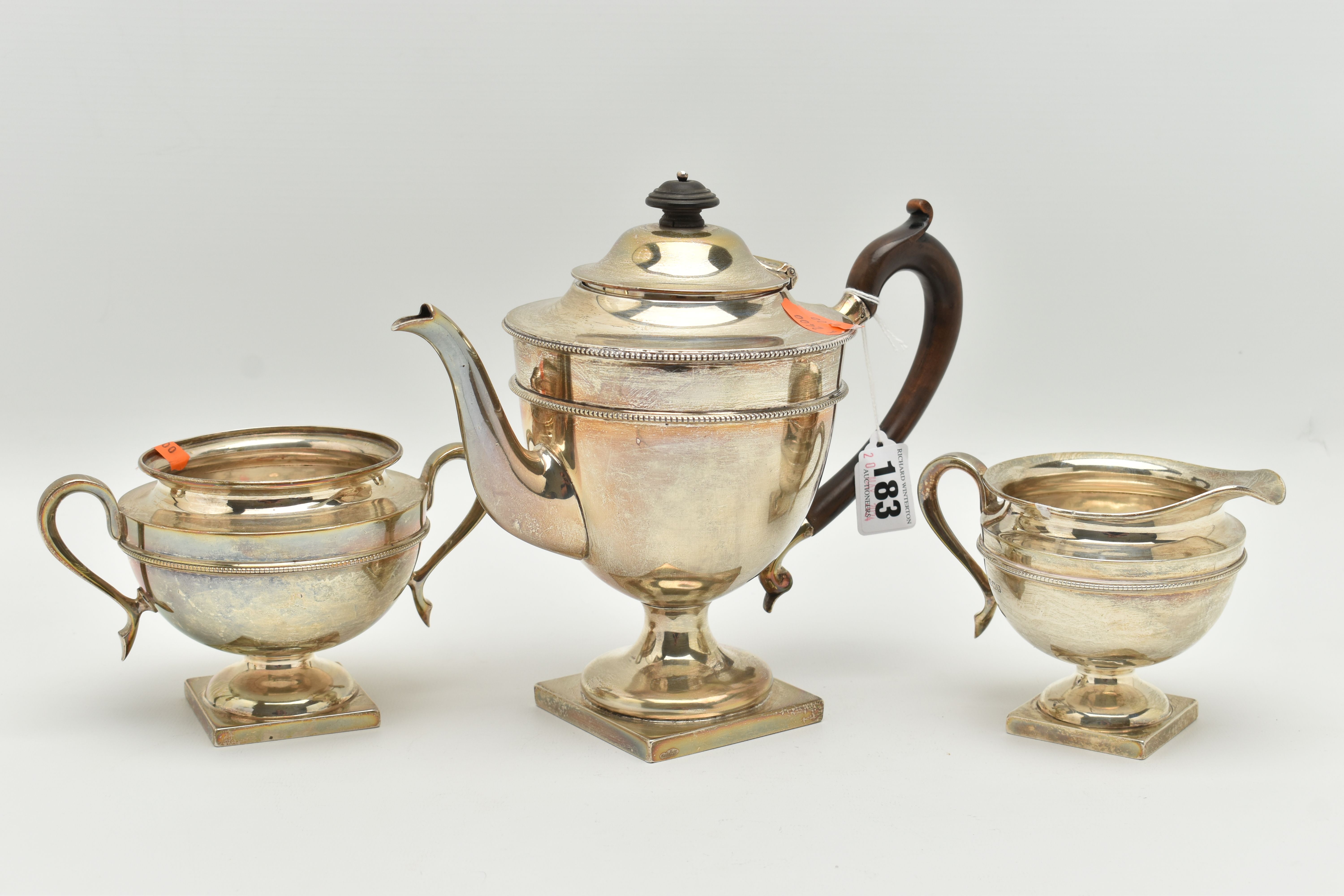 AN EARLY 20TH CENTURY SILVER THREE PIECE TEA SET, comprising of a teapot, sugar bowl and milk jug,
