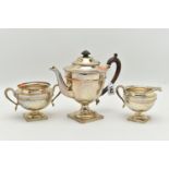 AN EARLY 20TH CENTURY SILVER THREE PIECE TEA SET, comprising of a teapot, sugar bowl and milk jug,