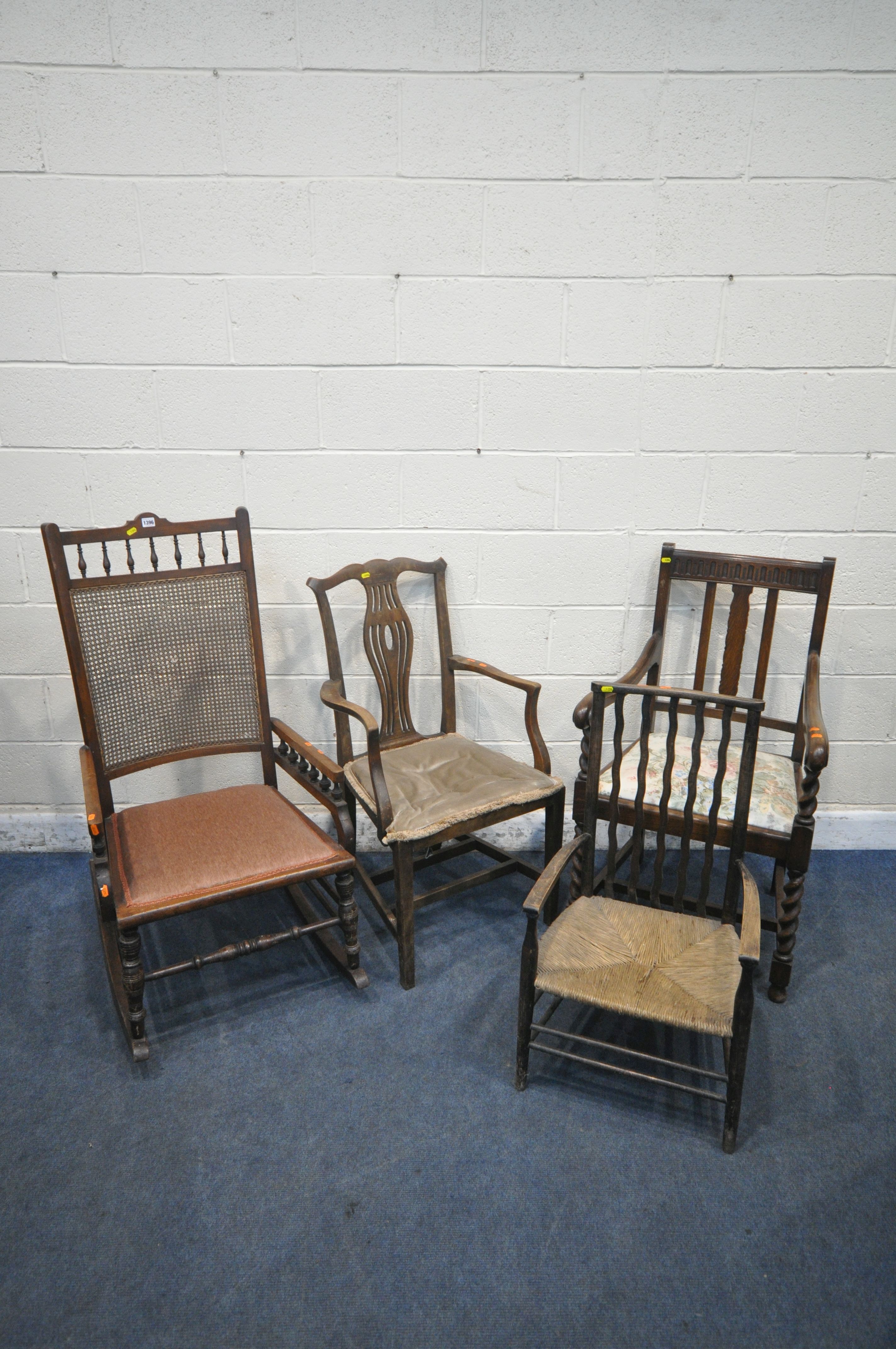 AN EDWARDIAN MAHOGANY BERGÈRE BACK ROCKING CHAIR, along with an oak open armchair, another