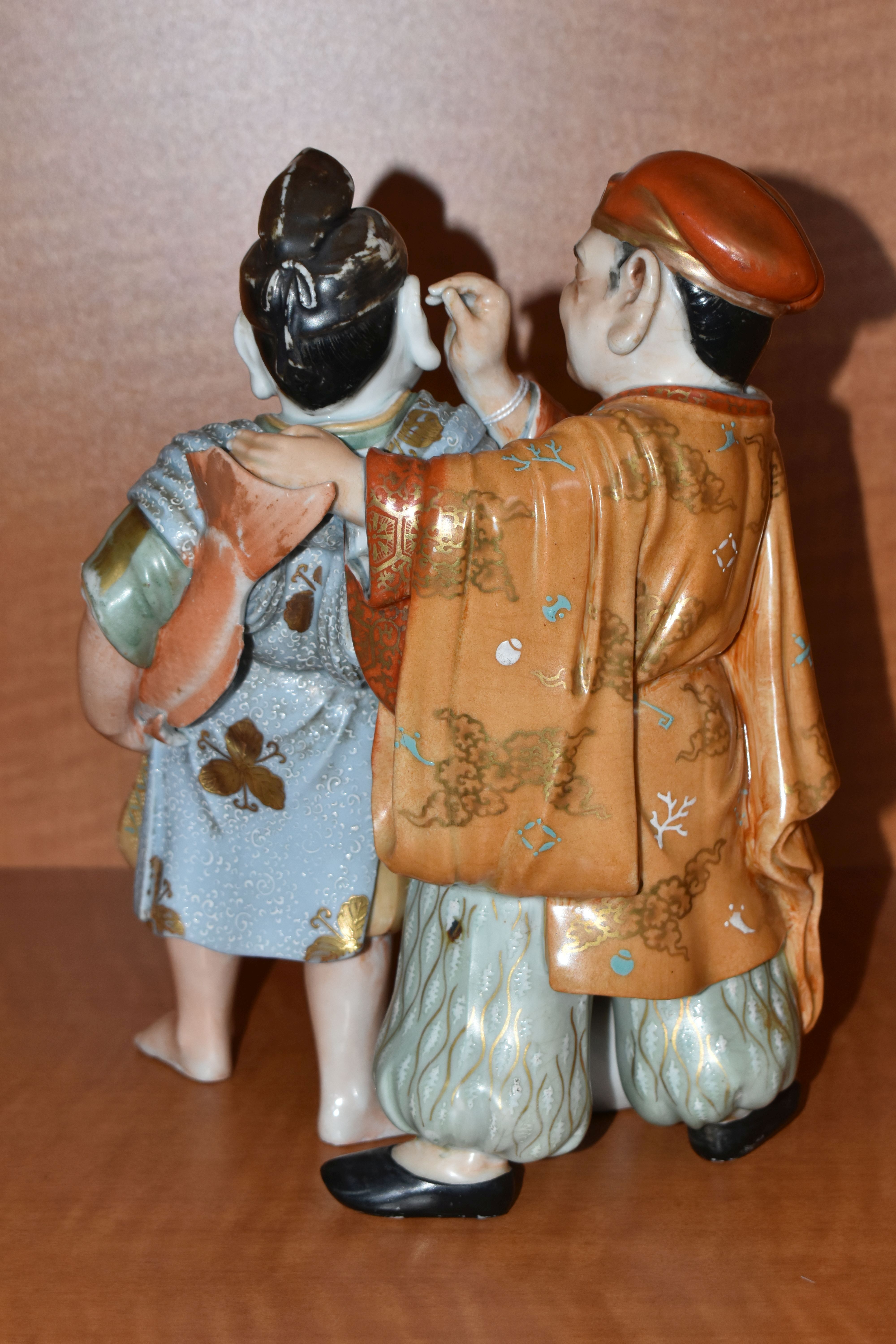 A LATE 19TH / EARLY 20TH CENTURY JAPANESE PORCELAIN FIGURE GROUP OF TWO MEN, one holding a carp - Image 4 of 9