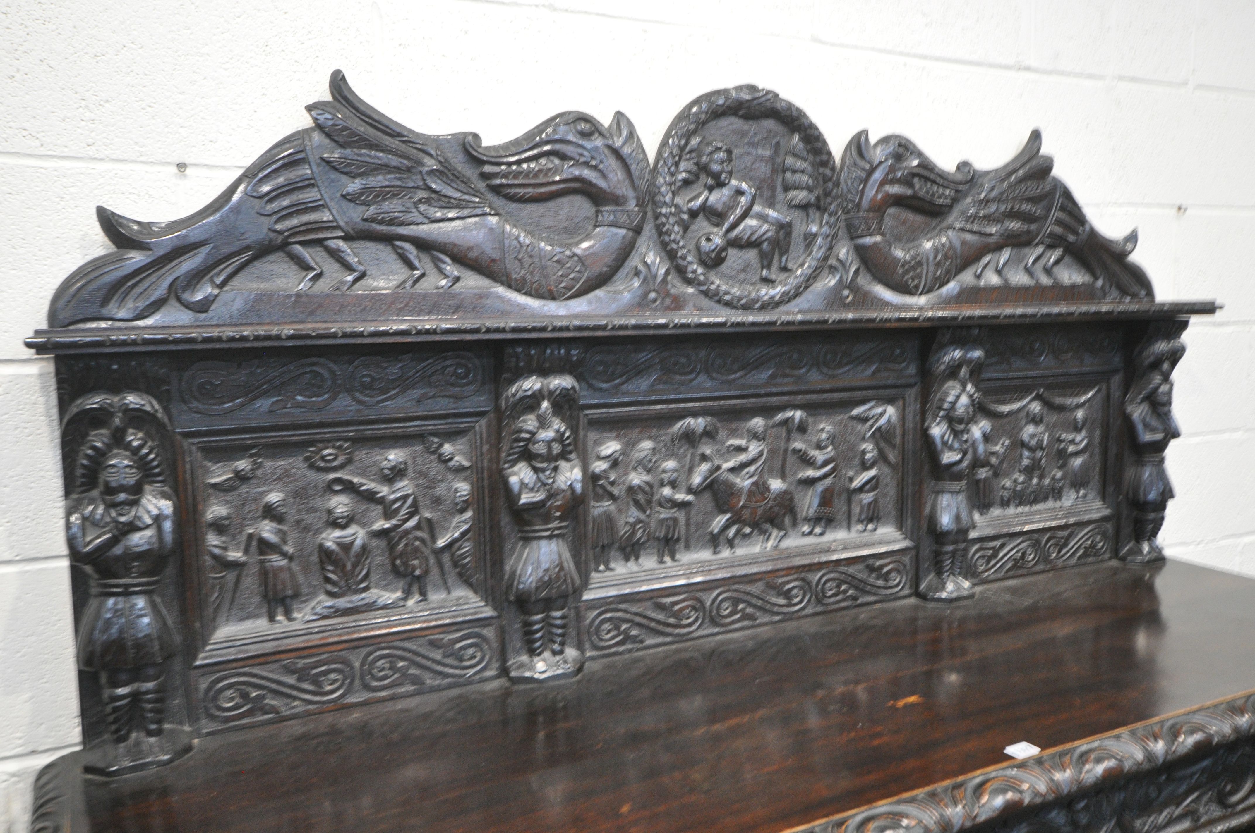 A 19TH CENTURY HEAVILY CARVED OAK SIDEBOARD, the raised back with panelling and shelf, fitted with - Image 3 of 10