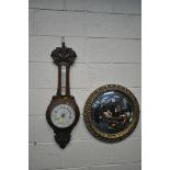 A CIRCULAR GILT FRAMED CONVEX WALL MIRROR, diameter 52cm, along with a carved oak barometer (