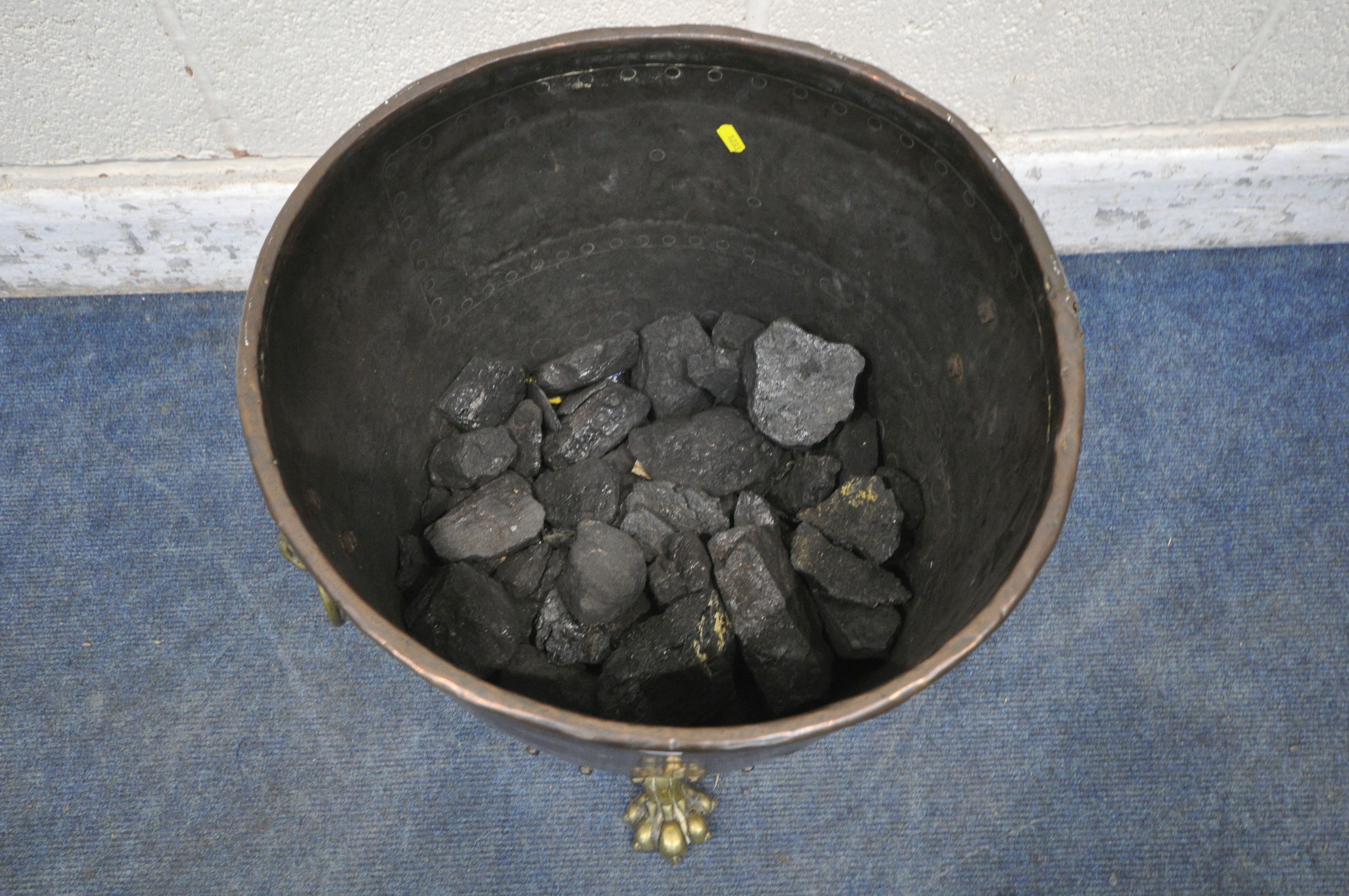 A 19TH CENTURY RIVETED BRASS AND COPPER COAL BUCKET, with lions head handles, and triple paw feet, - Image 3 of 5