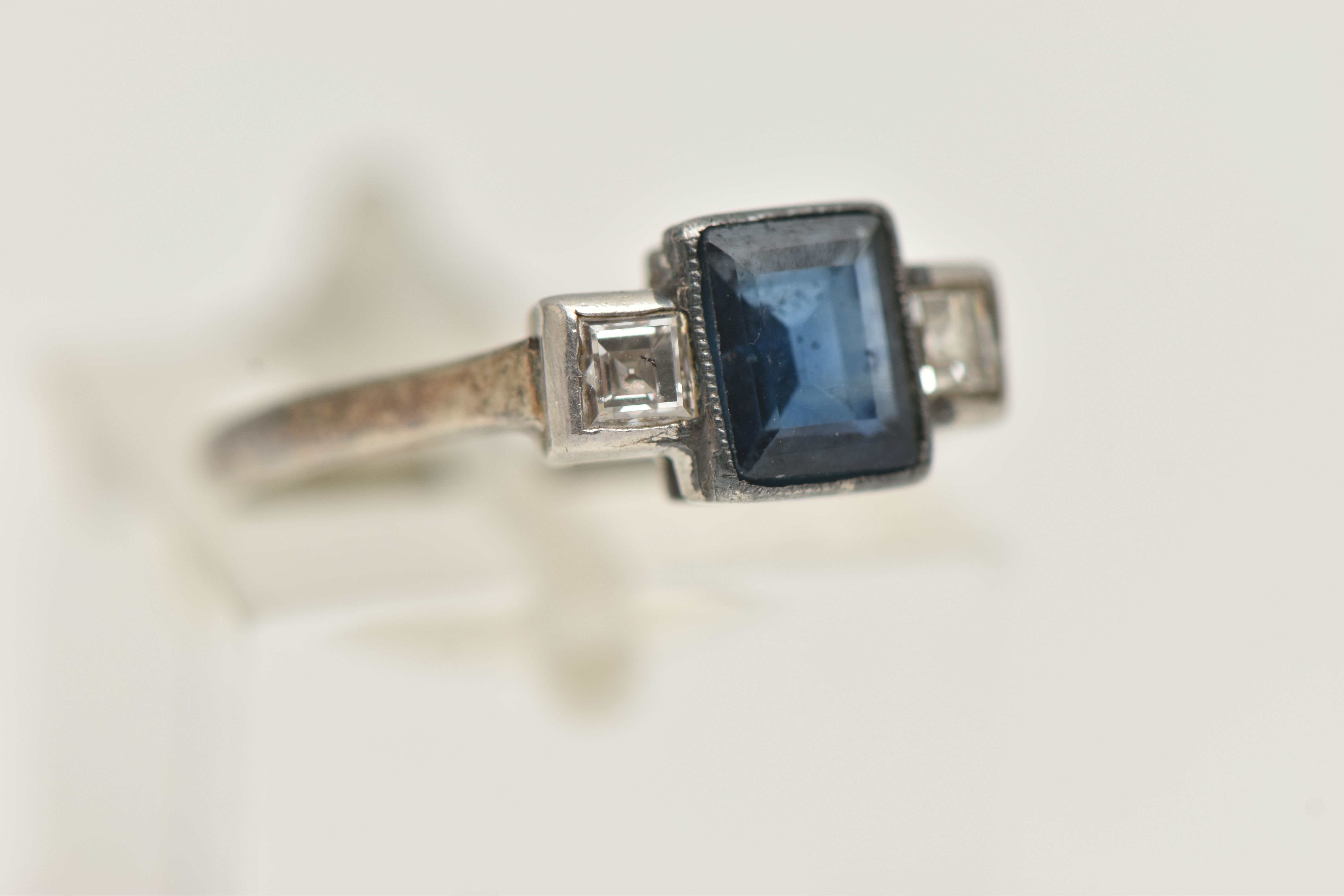 A SAPPHIRE AND DIAMOND RING, designed as a central rectangular cut treated sapphire in milligrain - Image 4 of 4