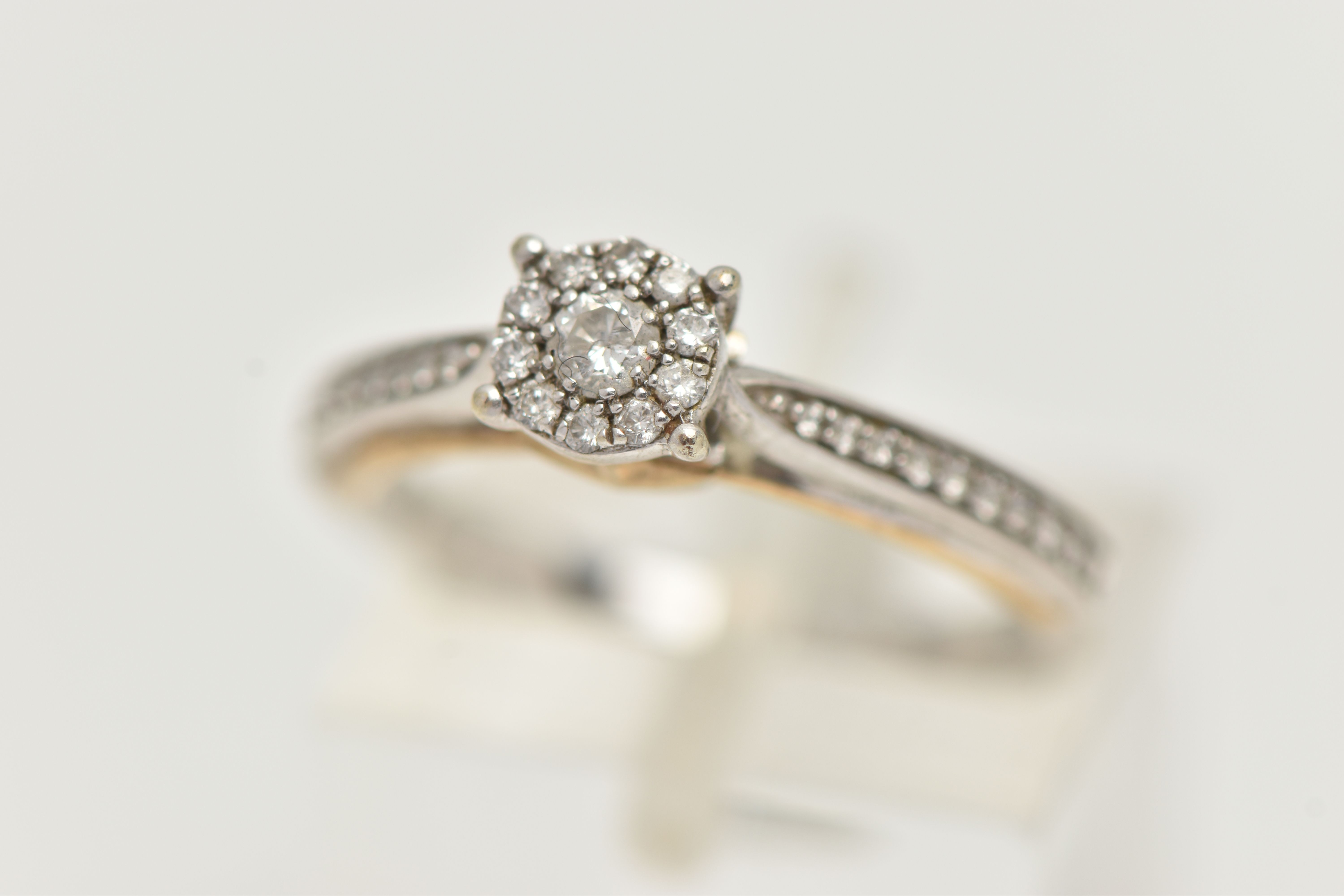 A 9CT WHITE GOLD DIAMOND RING, designed as a central brilliant cut diamond within a brilliant cut