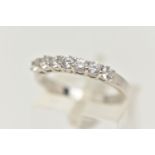 A 9CT WHITE GOLD CUBIC ZIRCONIA RING, designed as a line of seven circular cubic zirconia stones, to