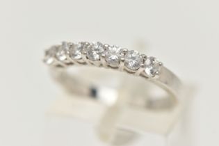 A 9CT WHITE GOLD CUBIC ZIRCONIA RING, designed as a line of seven circular cubic zirconia stones, to