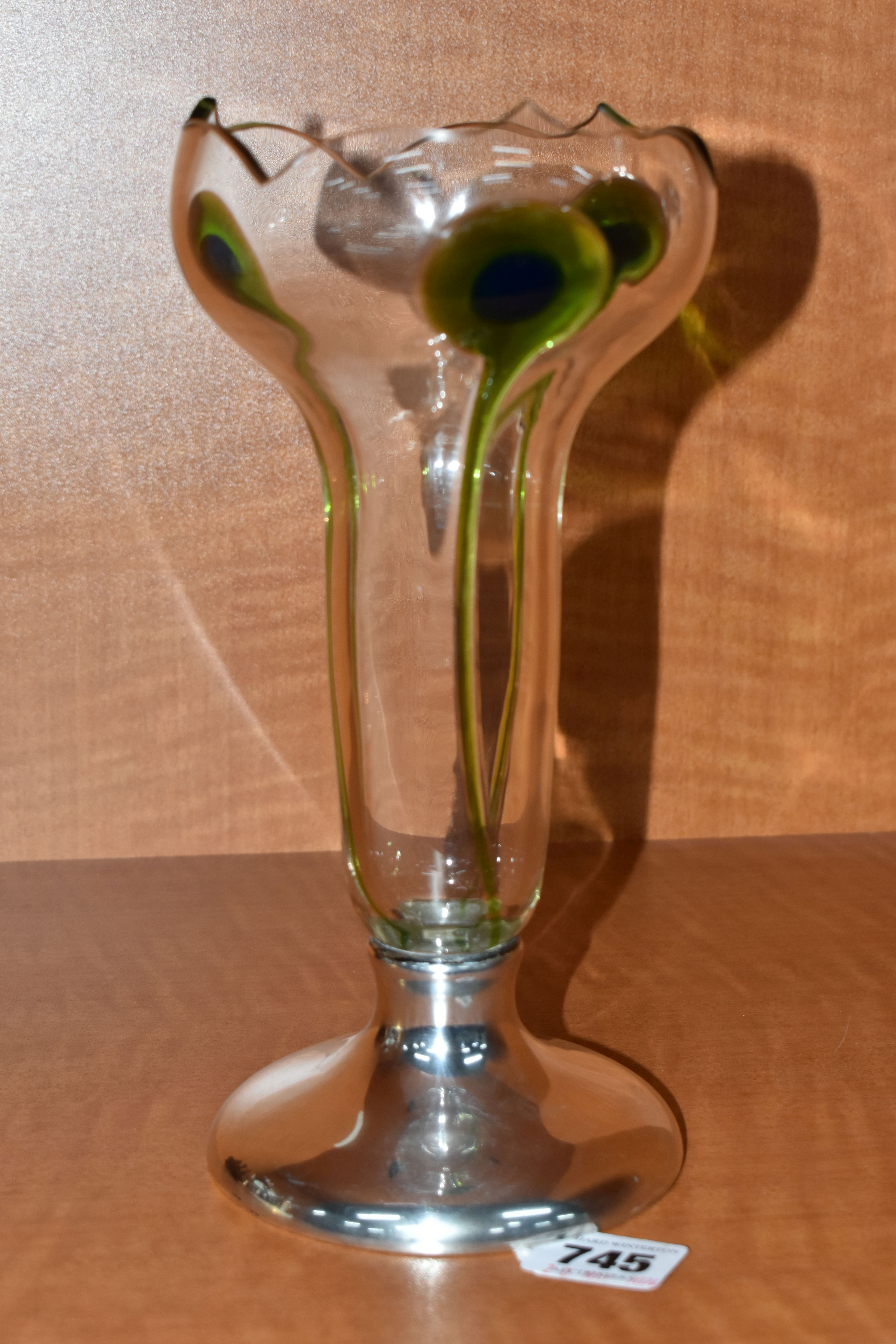 AN ART NOUVEAU SILVER MOUNTED CLEAR GLASS VASE WITH THREE GREEN AND BLUE PEACOCK FEATHER STYLE