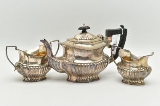 AN EDWARD VII THREE PIECE SILVER TEA SET, comprising of a Queen Anne style tea pot, milk jug and