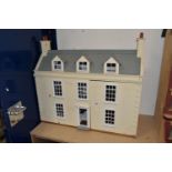 A LARGE MODERN WOODEN DOLLS HOUSE, modelled as a Georgian townhouse, front opening to reveal four