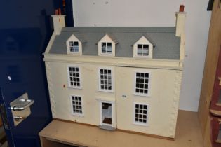 A LARGE MODERN WOODEN DOLLS HOUSE, modelled as a Georgian townhouse, front opening to reveal four