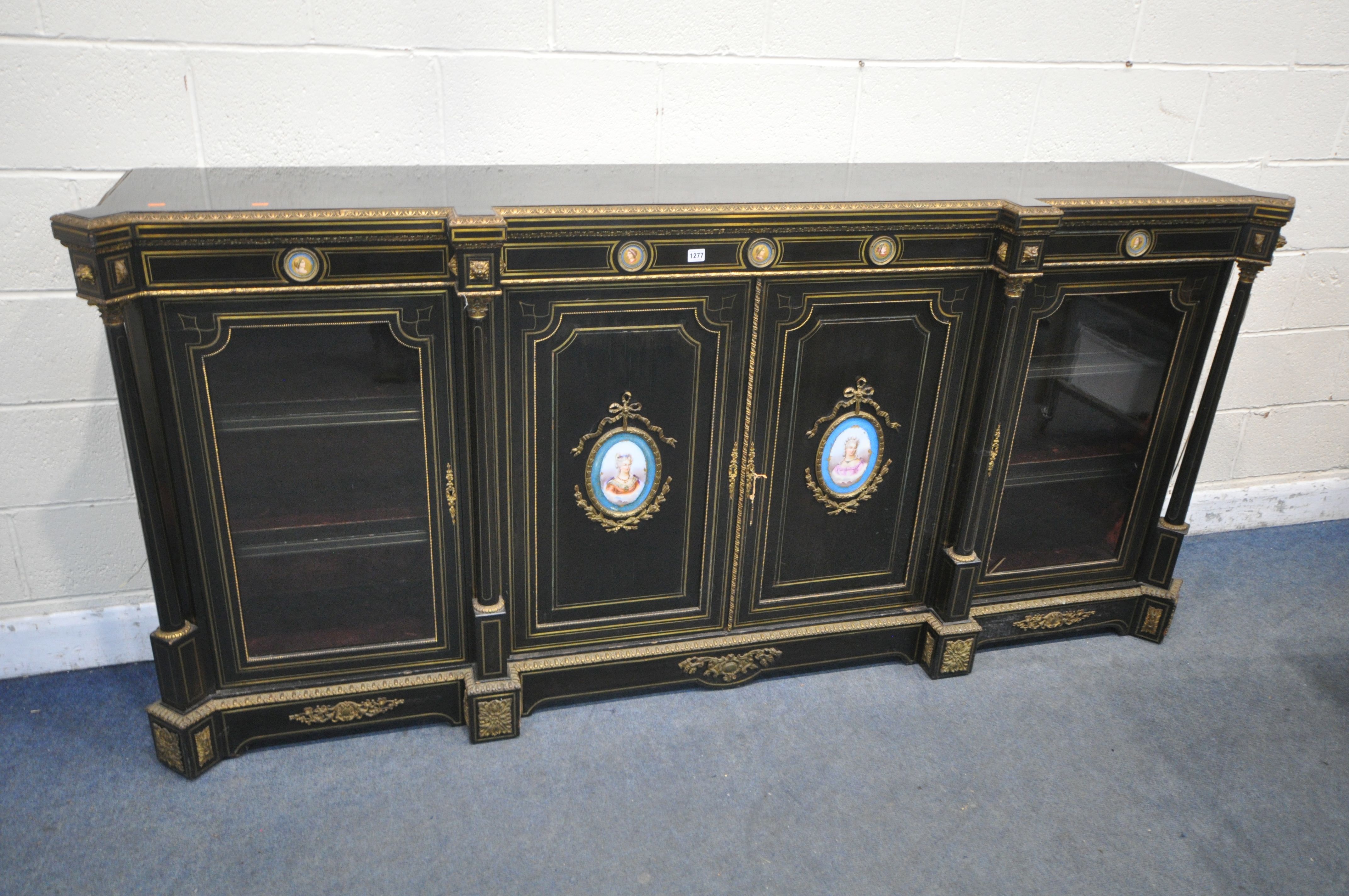 A 19TH CENTURY EBONISED AND GILT BRASS CREDENZA, with four moulded tops supporting Corinthian