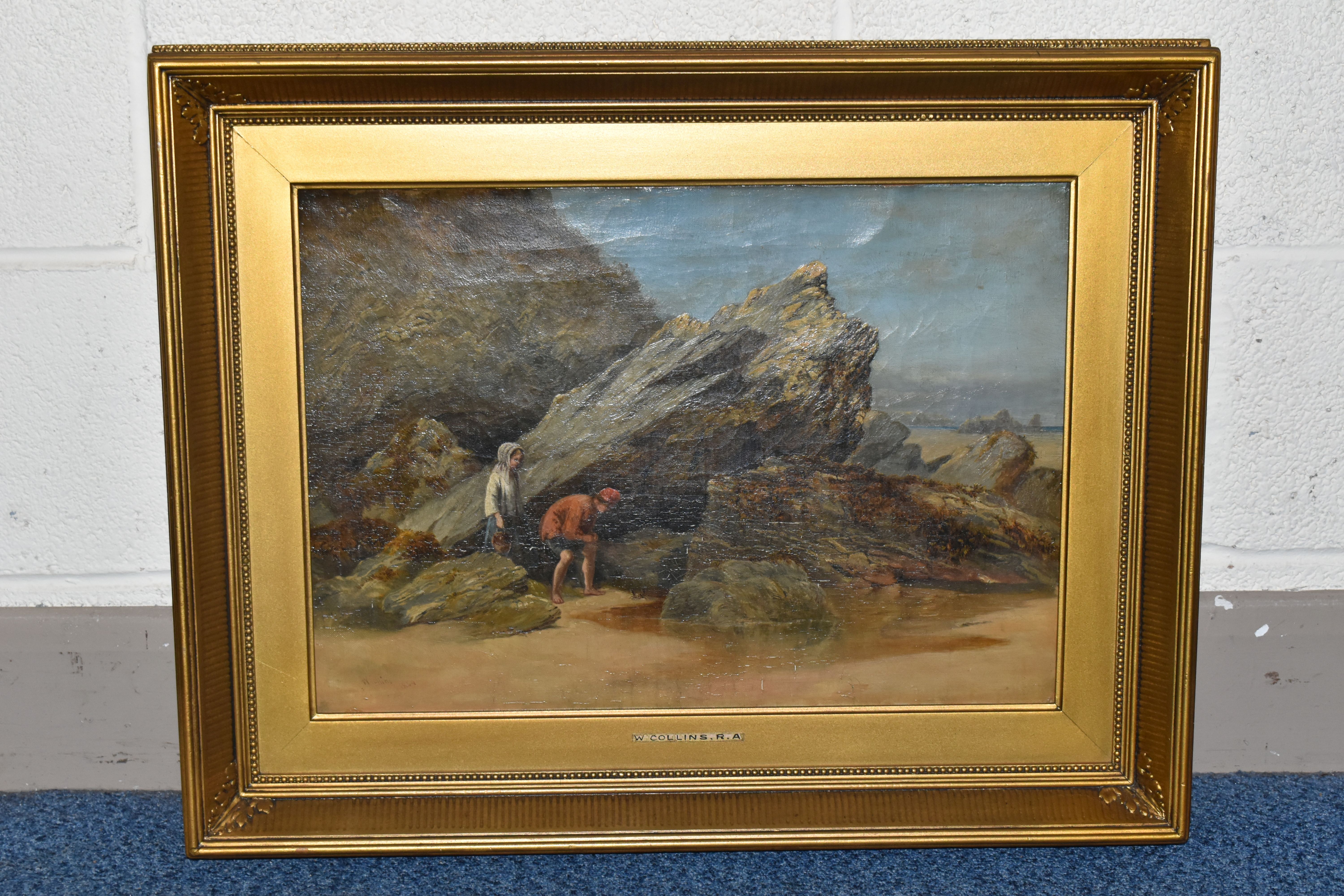 W. COLLINS (19TH CENTURY) A ROCKY COASTAL LANDSCAPE WITH FIGURES, a young male and female figures