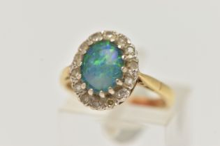 AN 18CT GOLD SYNTHETIC OPAL AND DIAMOND CLUSTER RING, the central oval synthetic opal cabochon