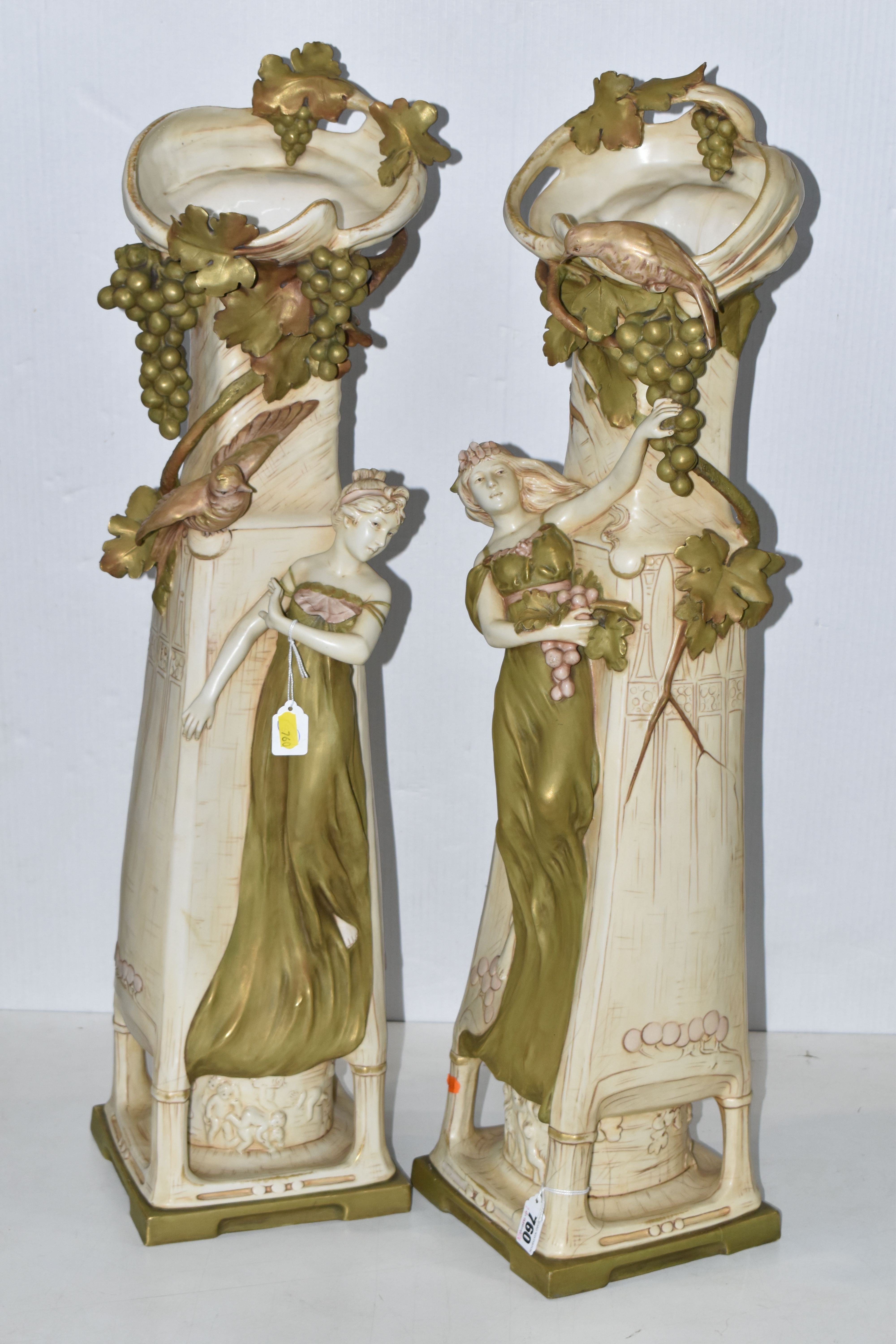 A PAIR OF ROYAL DUX ART NOUVEAU FIGURAL VASES, each modelled with a scrolling neck with fruiting