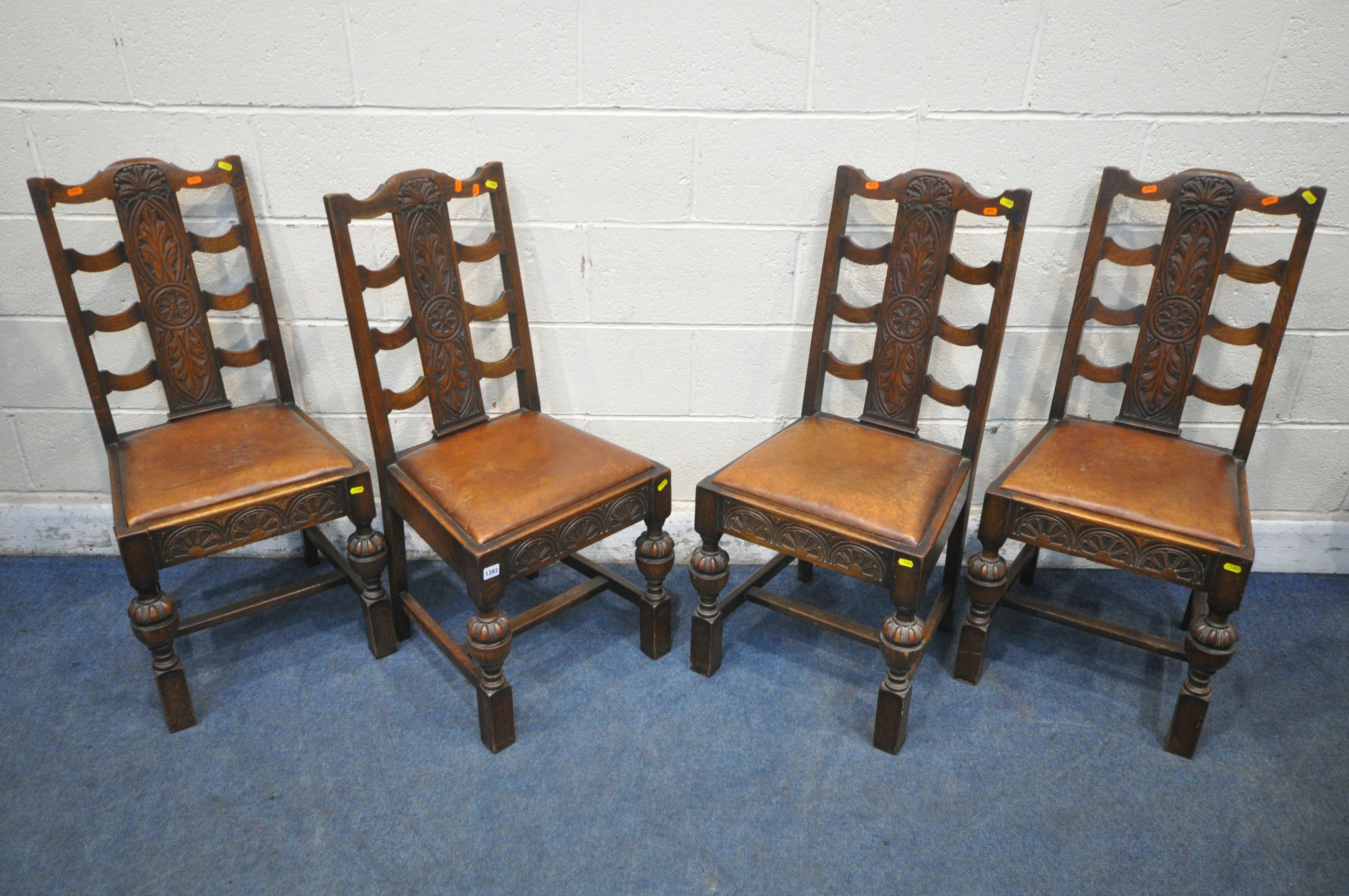 A SET OF EARLY 20TH CENTURY OAK DINING CHAIRS, with foliate backrests, brown leather seat pads,