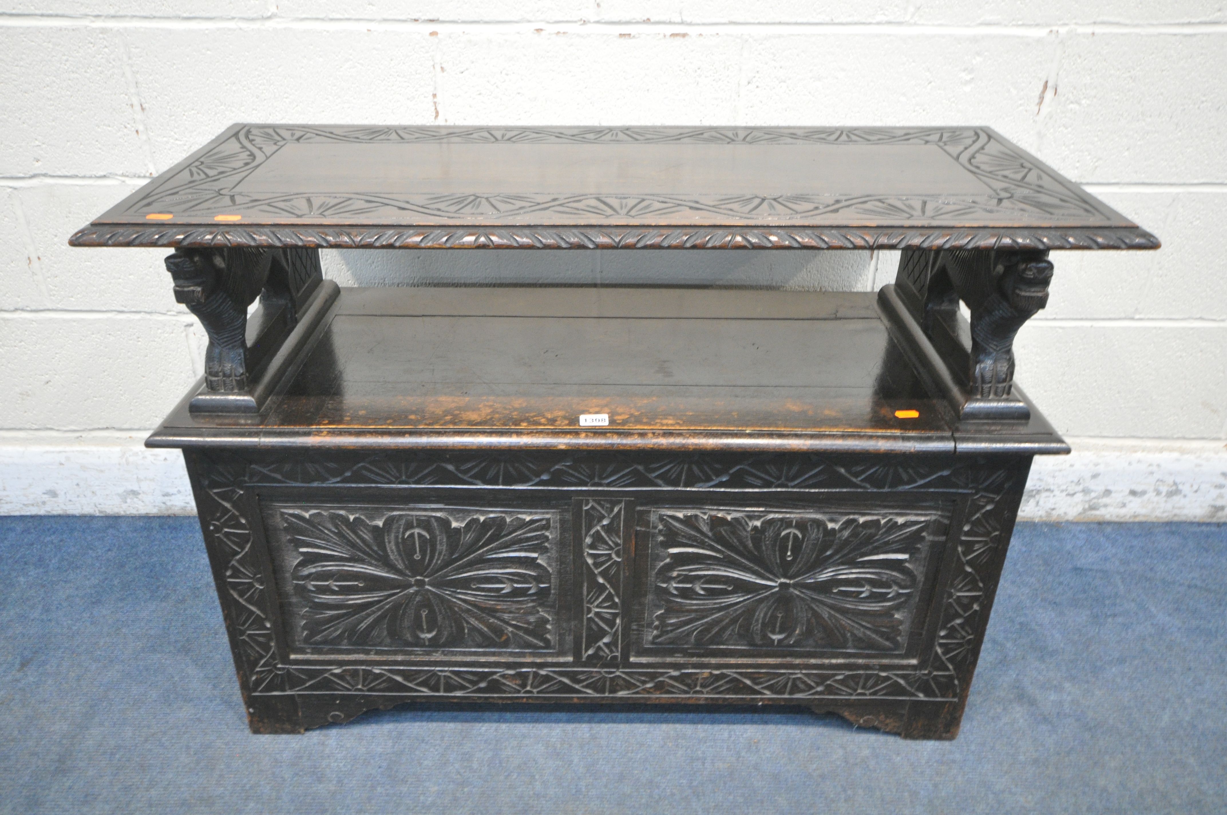 AN EARLY TO MID 20TH CENTURY DARK OAK MONKS BENCH, with lion armrests, flanking a hinged storage - Image 2 of 4