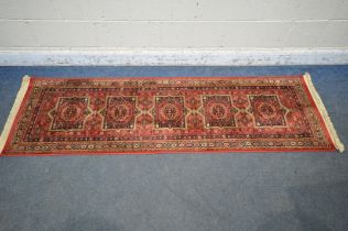 A LATE 20TH CENTURY SYNTHETIC RED PATTERNED CARPET RUNNER, 210cm (condition report: good)