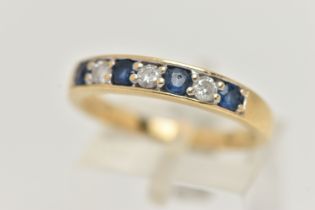 AN 18CT GOLD SAPPHIRE AND DIAMOND SEVEN STONE RING, designed as a line of four circular sapphires