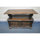 AN EARLY 20TH CENTURY OAK MONKS BENCH, with a rise and fall backrest / surface, lion armrests and