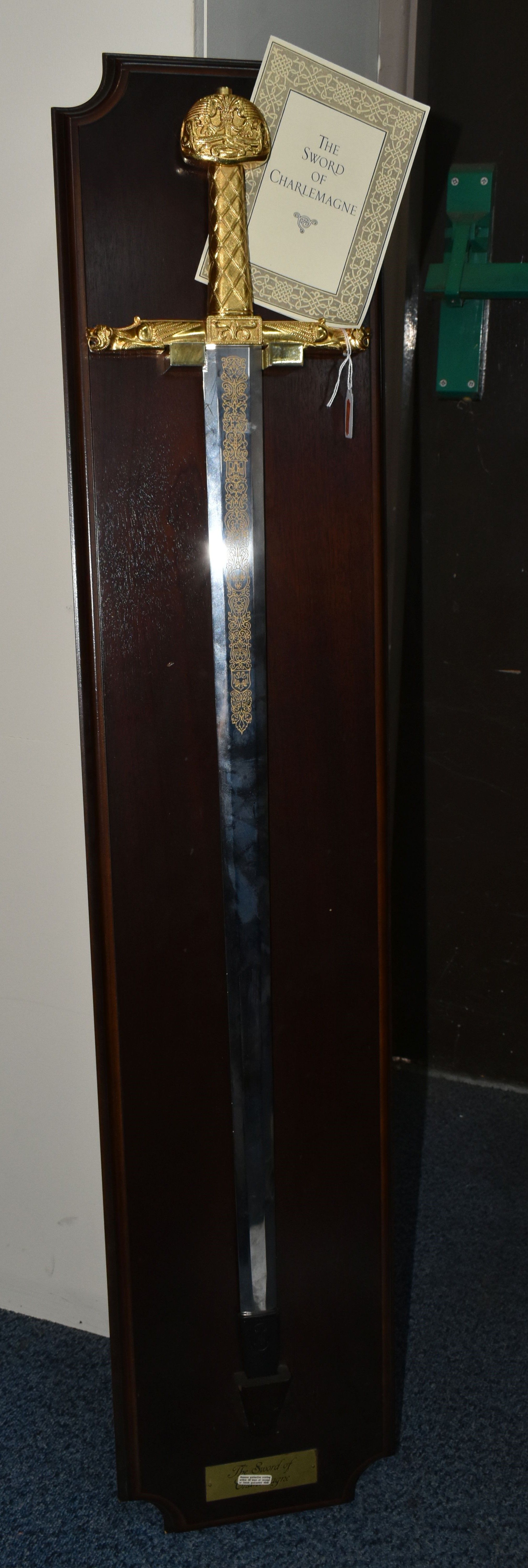 A REPRODUCTION FRANKLIN MINT SWORD OF CHARLEMAGNE WITH WOODEN DISPLAY BOARD AND CERTIFICATE, gold