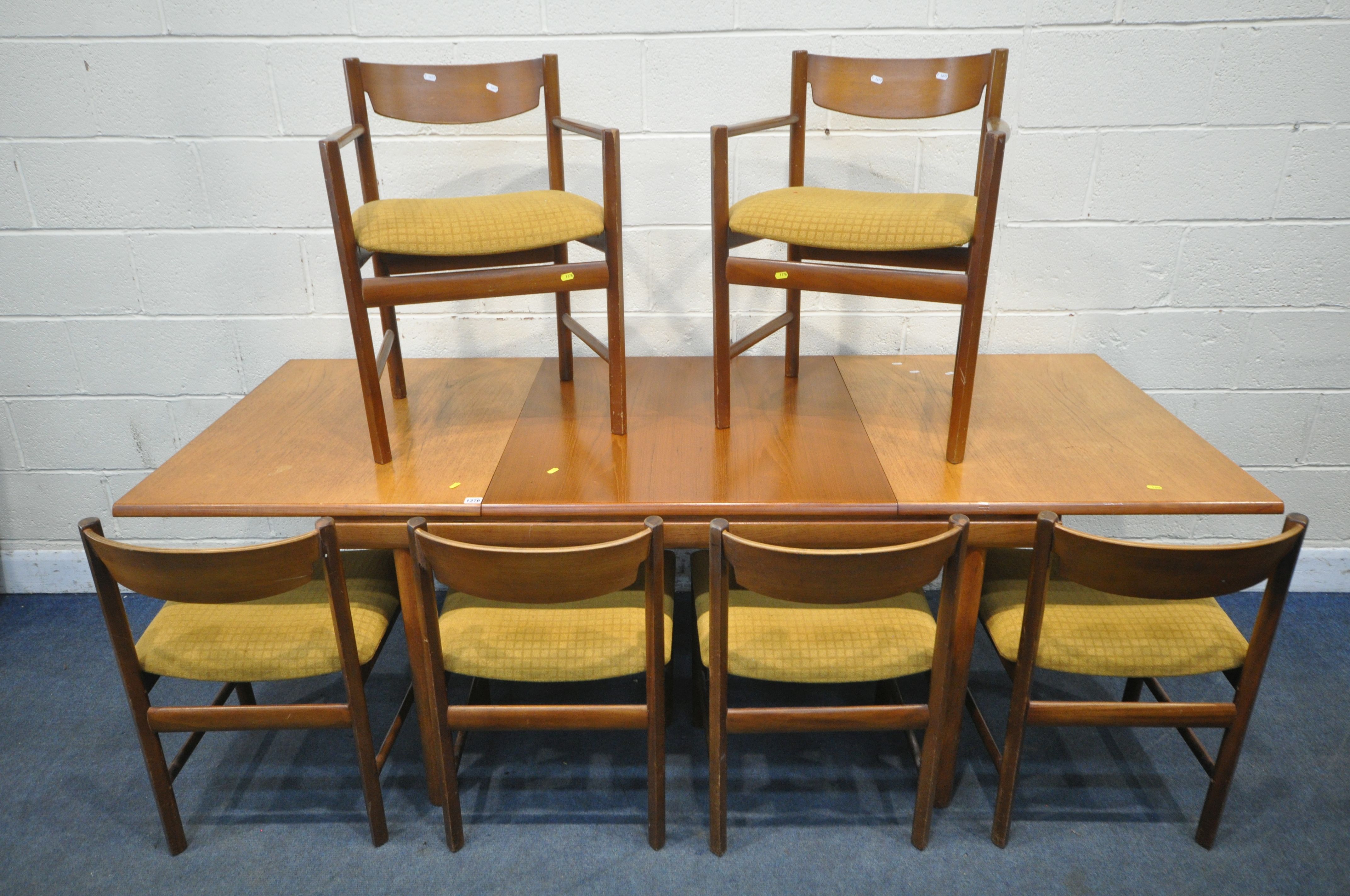 WHITE AND NEWTON LTD, A MID CENTURY TEAK EXTENDING DINING TABLE, with a single fold out leaf,