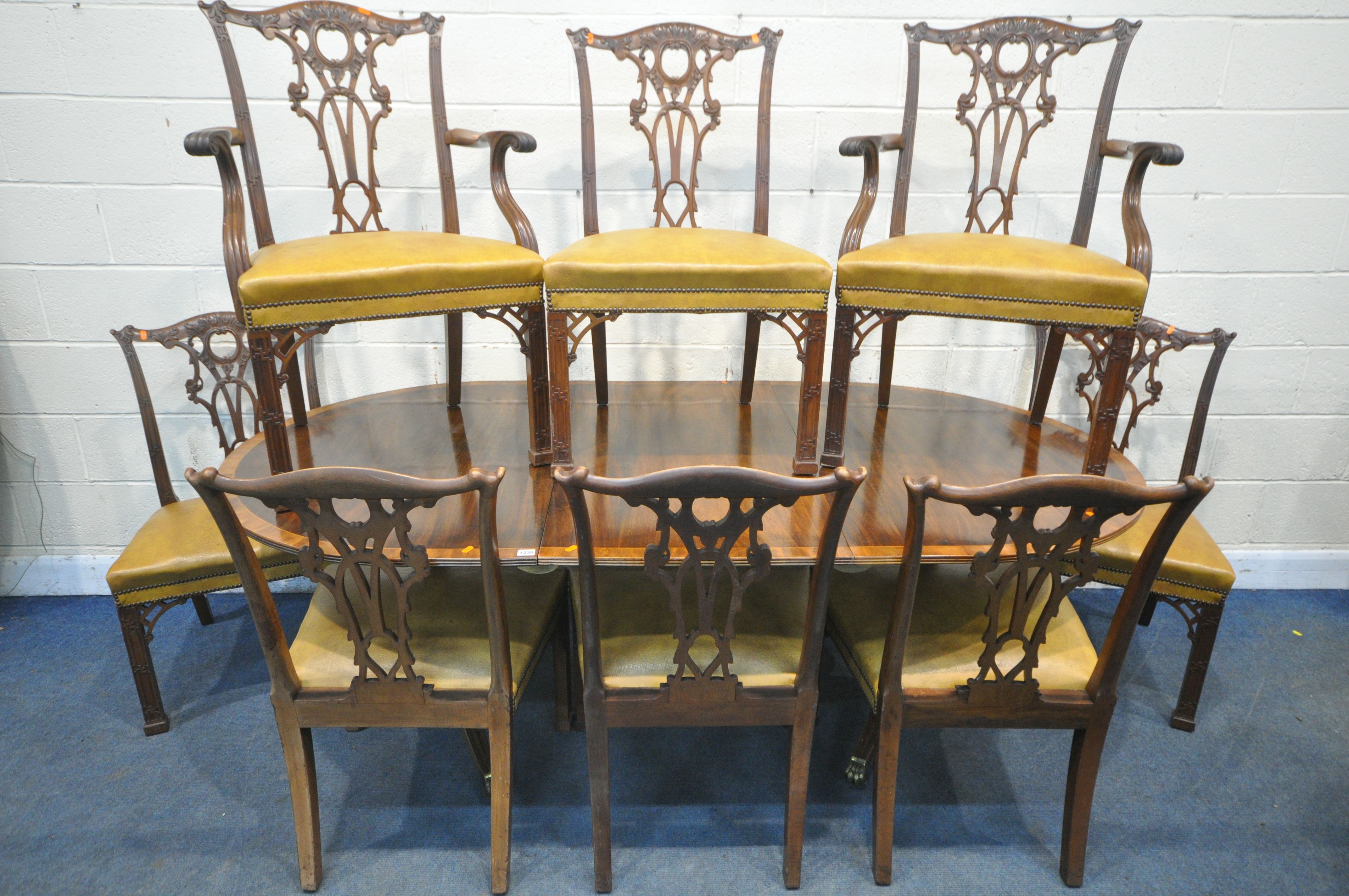 AN GEORGIAN STYLE MAHOGANY AND CROSSBANDED TWIN PEDESTAL DINING TABLE, with a single additional