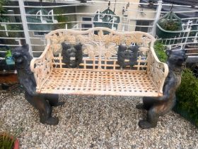 A CAST IRON BLACK FOREST STYLE GARDEN BENCH, the seat is supported by two angry black bears, the